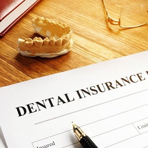a dental insurance form next to wax dentures