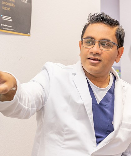 dentist showing patient xray on tv