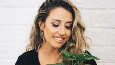 Woman looking at potted plant