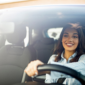 Woman smiling while driving home