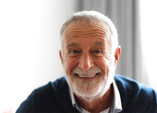 Senior man in blue shirt smiling