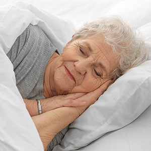 Senior woman sleeping peacefully in bed